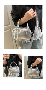 Detail of silver metallic bowling bag with pearl bow charm and detachable strap