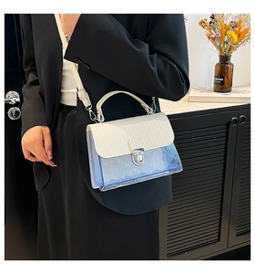 Detail of transparent blue quilted crossbody bag with white flap and metal lock clasp