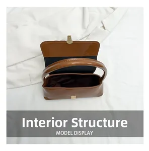 Internal structure of the brown glossy shoulder bag showing the dark lining and spacious interior