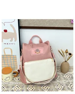 Detail of color-block pink and white waterproof nylon backpack with a rabbit patch