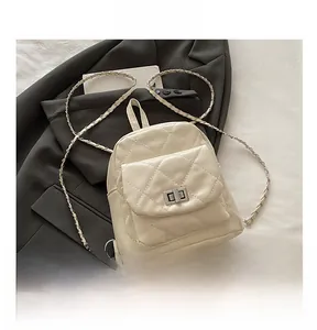 Quilted mini backpack with silver metal turn-lock and chain strap on a black suit