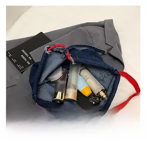 Interior view of denim tote bag showing spacious capacity with personal essentials