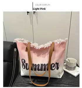 Detail of canvas tote bag with pink gradient, summer lettering and brown leather straps