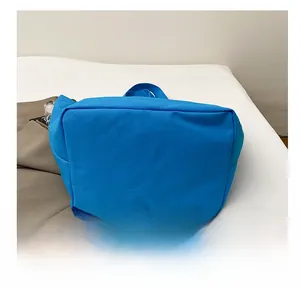 Detailed view of durable reinforced bottom and stitching on royal blue canvas tote bag