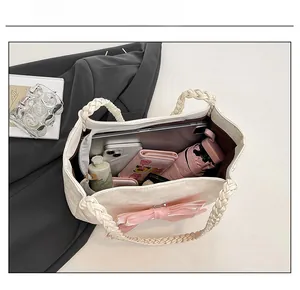 Top view of cream tote bag with pink bow showing large storage capacity for essentials