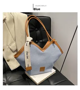 Detailed view of blue woven tote bag with V-shaped opening and brown leather edge
