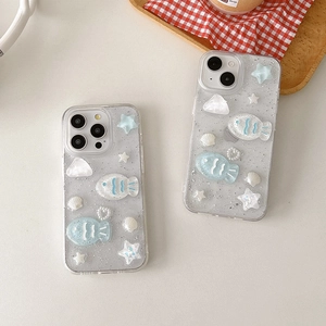Detail of ocean-themed iPhone case featuring silver glitter, blue resin fish and shell accents