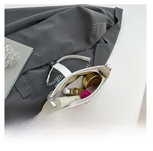 Interior view of large capacity white woven bag showing cosmetics and adjustable strap