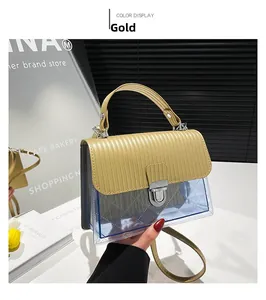 Detail view of gold textured faux leather flap and silver metal twist lock on jelly bag