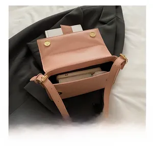 Pink pebbled leather baguette bag interior showing capacity for phone and accessories
