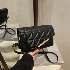 Black quilted crossbody bag with golden metal hardware and elegant chain strap for women