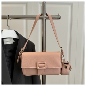 Detail of pink lychee textured leather shoulder bag with detachable mini coin purse