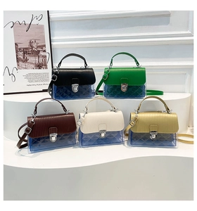 Multiple colorful transparent jelly handbags with metal locks on display stand