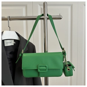 Close-up of bright green lychee texture handbag with square buckle and mini coin pouch