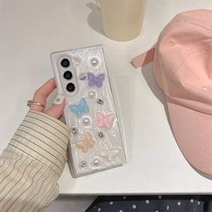 Macro detail of 3D resin butterflies and pearls on a clear phone case for Z Flip 6