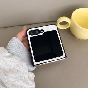 Close-up of white lychee leather texture on a folding phone case with black edges