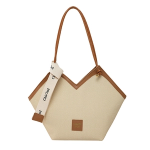 Vintage beige woven tote bag with brown leather trim and V-shaped opening for daily commute