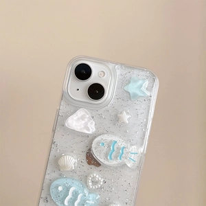 Macro shot of 3D resin fish and shells on glitter silver foil clear phone case