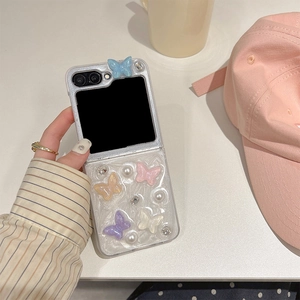 Detail of 3D butterfly and pearl rhinestones on a pearlescent folding phone case