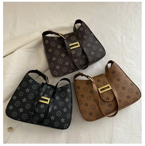 Three large capacity underarm bags with monogram patterns in black and brown shades