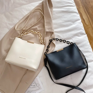 Fashionable PU leather bucket bags in beige and black with metal chain and gold details