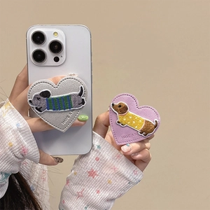 Heart-shaped leather phone grip with dachshund embroidery and Have a Nice Day slogan