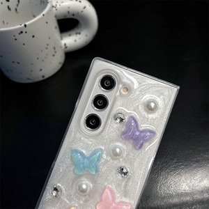 Detail of glitter phone case featuring 3D butterflies, pearls and rhinestones on the back