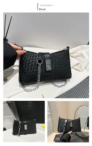 Close-up of black woven texture underarm bag with silver buckle and metal chain strap