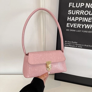 Pink crocodile-embossed faux leather shoulder bag with golden metallic lock closure