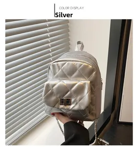 Silver quilted mini backpack with metallic finish, metal turn-lock and chain strap