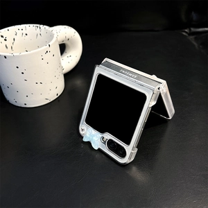 Macro detail of transparent Z Flip case with glitter blue butterfly and rhinestone accents
