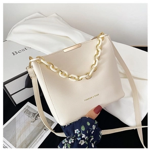 Minimalist cream bucket bag for women with gold chain strap and textured finish