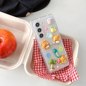 Detail of transparent Samsung Z Flip 6 case with 3D resin bear and fruit charms