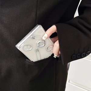 Detail view of heart paperclip folding phone case with silver metal charms in a pocket
