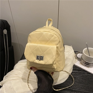 Quilted cream yellow mini backpack with silver metal chain and rhombus stitching