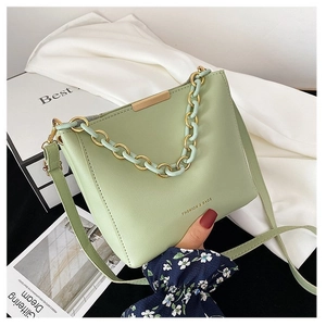 Chic mint green leather bucket bag with resin chain and minimalist fashion design