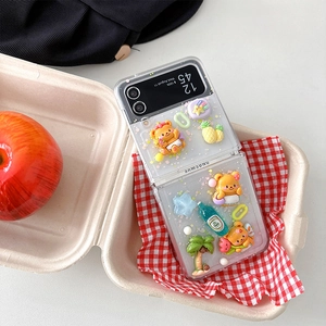 Detail of cute bear and pineapple 3D charms on a glitter Z Flip case for women