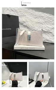 Close-up of white woven leather texture with silver metal buckle and chain strap