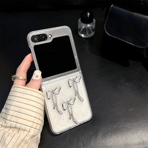 Detail of glitter phone case for Samsung Galaxy Z Flip with silver bow accents