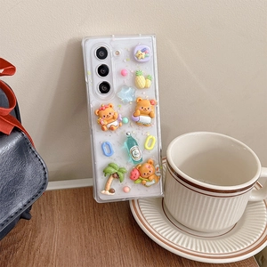 Close-up of 3D resin bear and fruit charms on clear case for Galaxy Z Fold