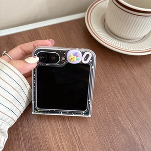Detail of transparent Galaxy Z Flip case with 3D star charms and glitter accents