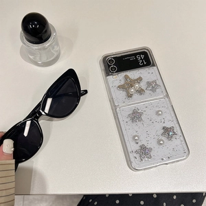 Glittery Samsung Galaxy Z Flip case featuring embossed silver stars and white pearls deco