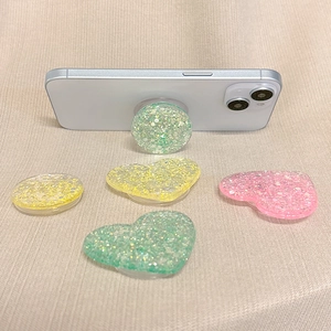 Macro shot of glittery heart and round phone sockets on a textured fabric surface