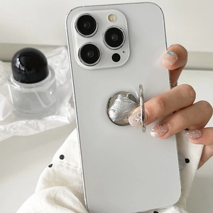 Silver round metal ring holder foldably attached to a minimalist white phone case