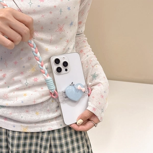 Detailed view of blue glitter heart phone clip with colorful braided crossbody strap