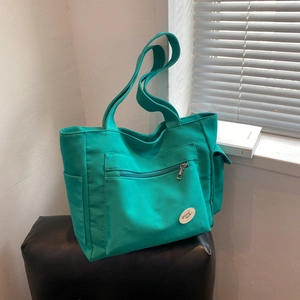 Grote groene canvas tote bag met ritsvak aan de voorkant en zijvakken voor dames