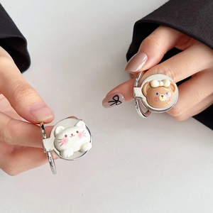 Detail of cute bear and cat phone ring holders with bowknot and metallic finish