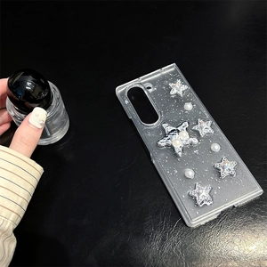 Macro detail of clear glitter phone case with silver stars and pearls for Z Fold 5 6