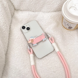 Detailed close-up of a pink woven crossbody strap and cute cartoon dachshund phone case