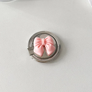 Detail of round metal phone ring holder with a 3D pink matte bowknot decoration